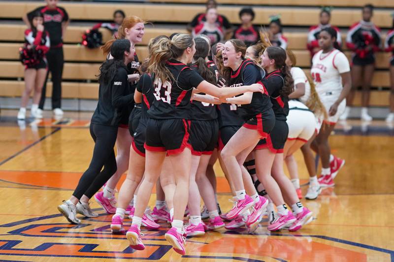 Benet players celebrate their victory over Bolingbrook at the conclusion of their Oswego 4A Sectional semifinal at Oswego High School on Tuesday, Feb 20, 2024.