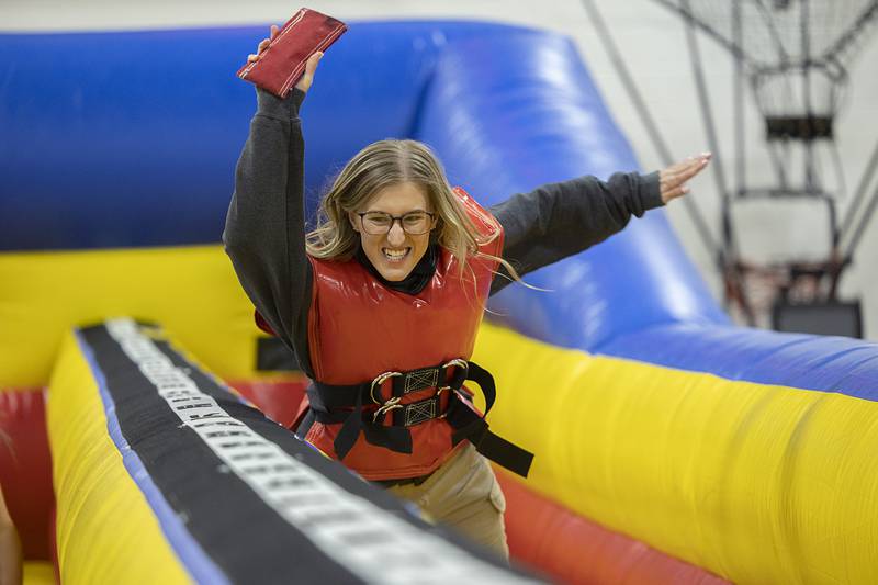 SVCC police academy student Kaitlyn Swemline reaches out to score while being tethered to a bungee Wednesday, Jan. 31, 2024 at Sauk Fest. The school brought in a number of fun inflatables as a welcome back to students.