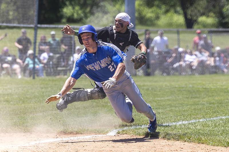 Newman’s Brendan Tunink gets by North Boone catcher Margarito Espain while tagging on a sacrifice fly Saturday, May 25, 2024 at the Byron 2A sectional final.