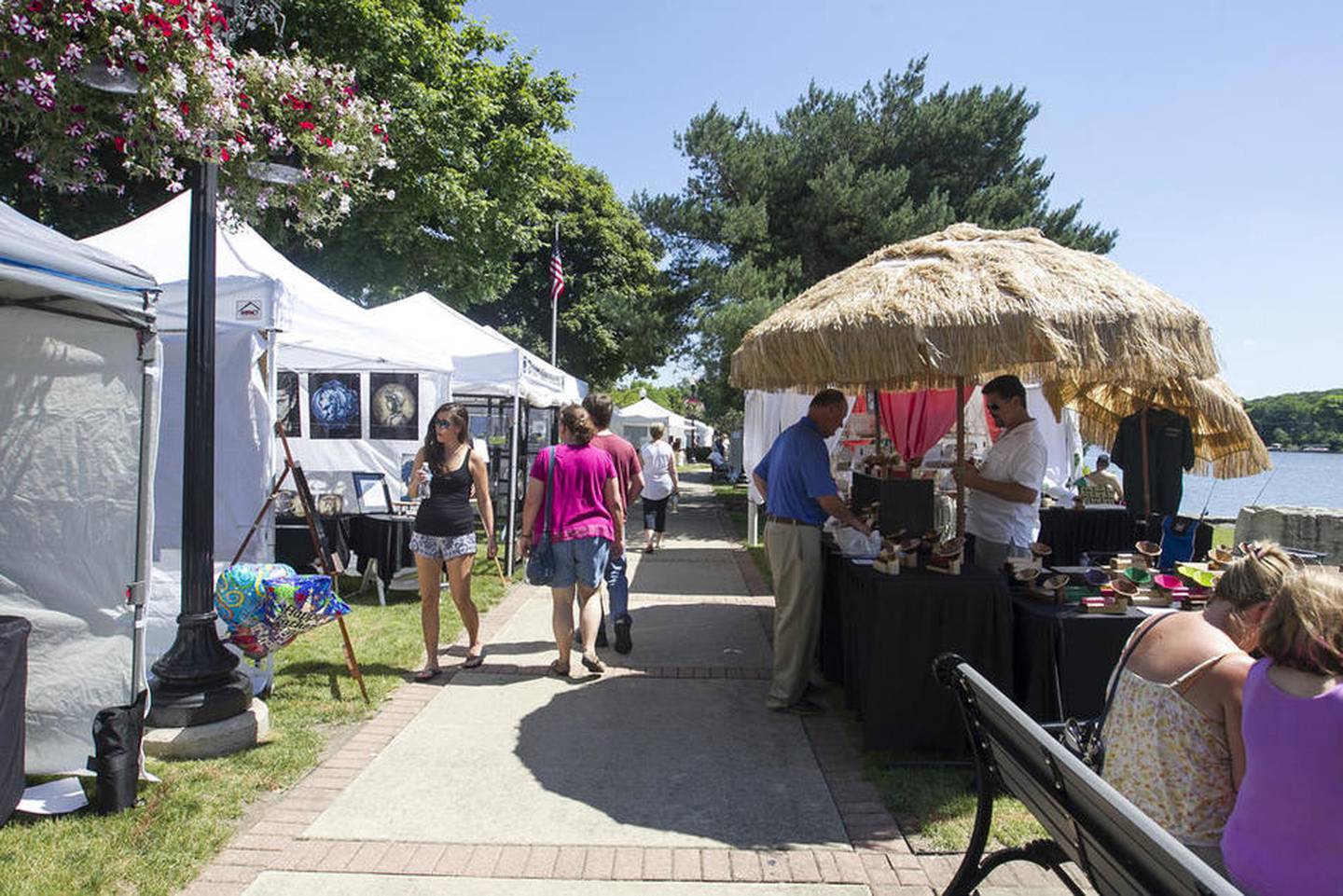 Attendees view art during the ninth annual Art on the Fox Fine Art Show on June 19, 2016 in Algonquin.