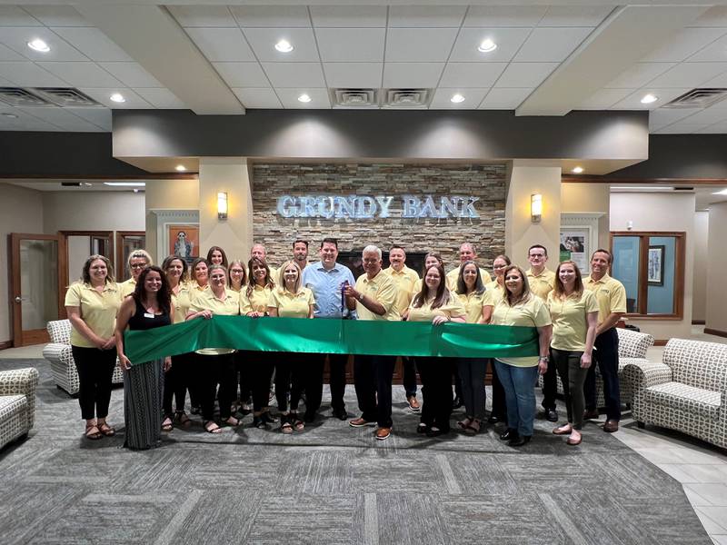 Employees of Grundy Bank celebrate its 160th anniversary with a ceremonial ribbon cutting inside its Downtown Morris location, 201 Liberty St.