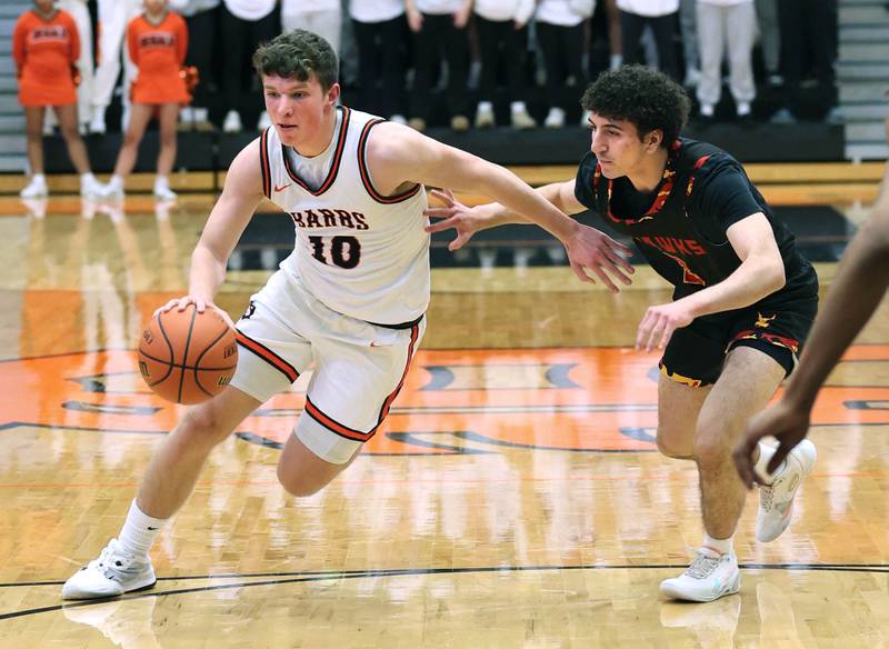 DeKalb’s Eric Rosenow drives by Jefferson's Samed Shakh Wednesday, Feb. 21, 2024, during their Class 4A regional semifinal game at DeKalb High School.