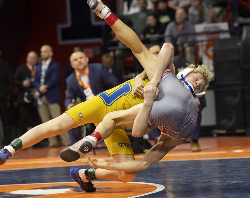 Johnsburg’s Eric Bush throws Vandalia’s Max Philpot in the 1A 106 pound championship match Saturday, Feb. 17, 2024 at the IHSA state wrestling finals at the State Farm Center in Champaign.