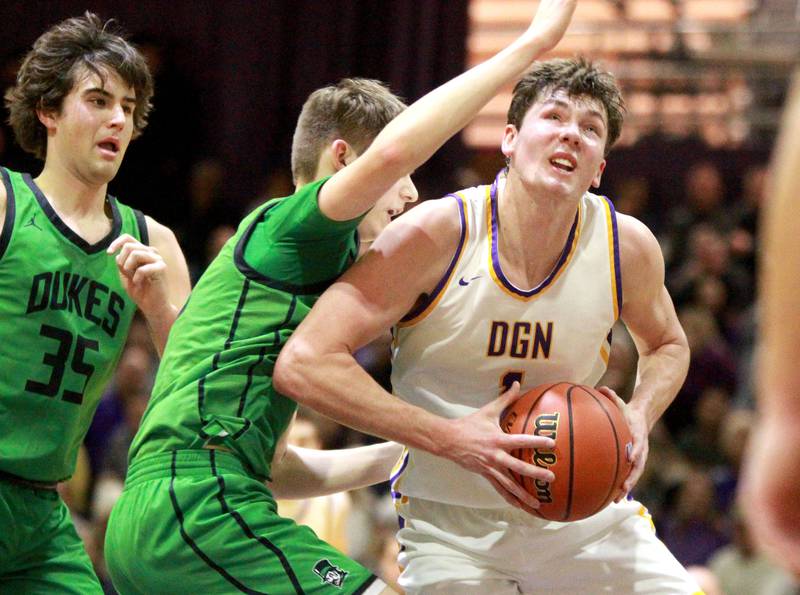 Downers Grove North’s Jake Riemer looks for an opening from under the basket during a game against York at Downers Grove North on Friday, Jan. 19, 2024.