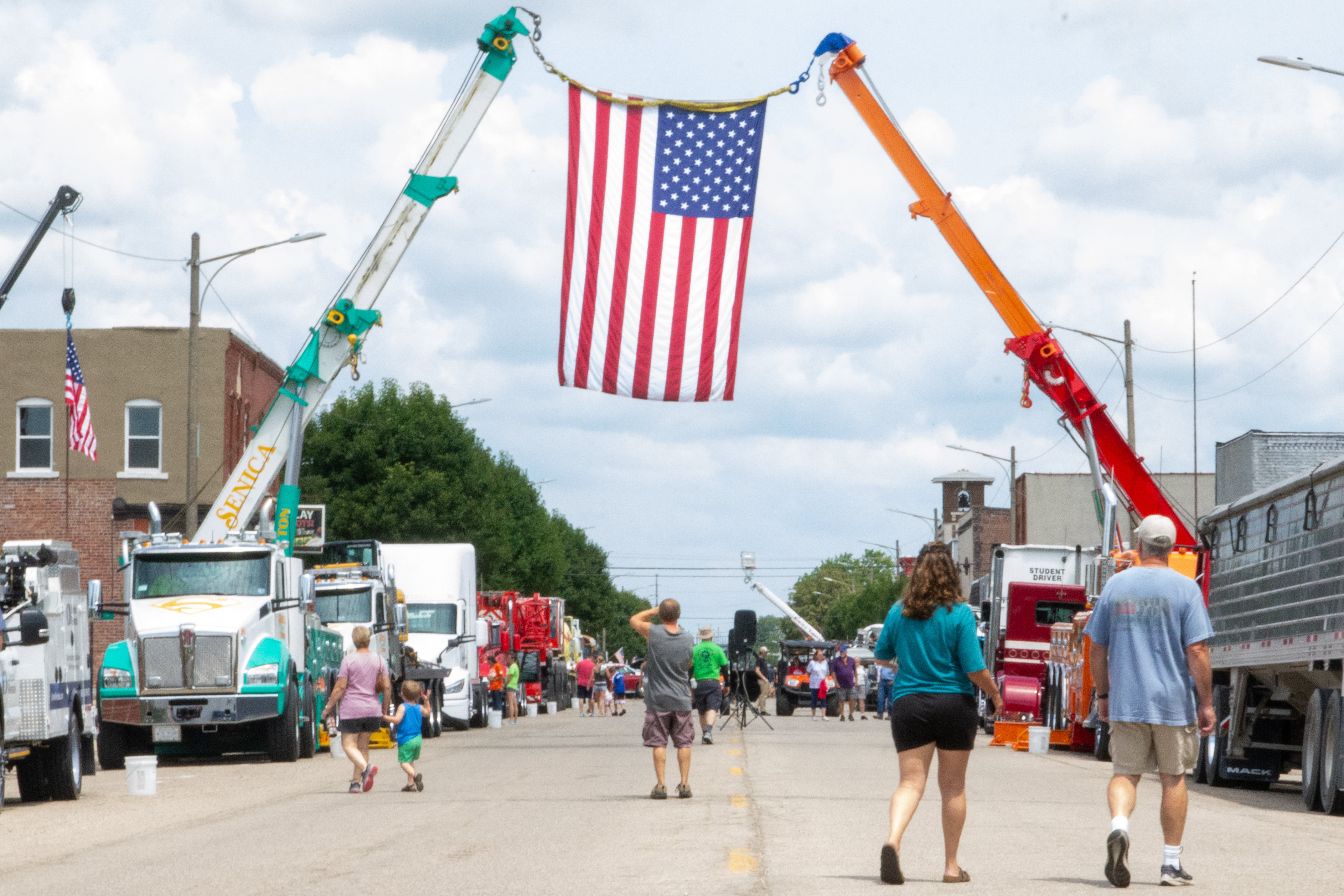 People walk through the Convoy Against Cancer Big Truck Show on Saturday, July 20, 2024 on Main Avenue in Ladd.