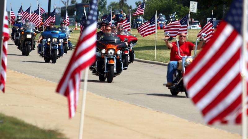 A  motorcade approaches as McHenry Community High School hosted a celebration Sunday for veterans returning from an Honor Flight trip to Washington D.C. The Honor Flight trip was coordinated by the Veterans Network Committee of Northern Illinois.