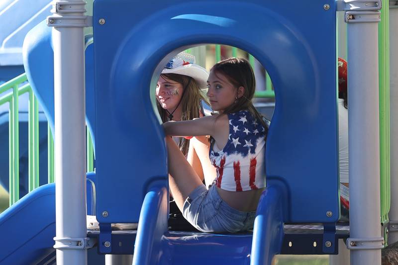 Kylie Lindstrom, left, and her cousin Anna Lindstorm hang out at the playground at Dellwood Park in Lockport on Wednesday July 3, 2024.