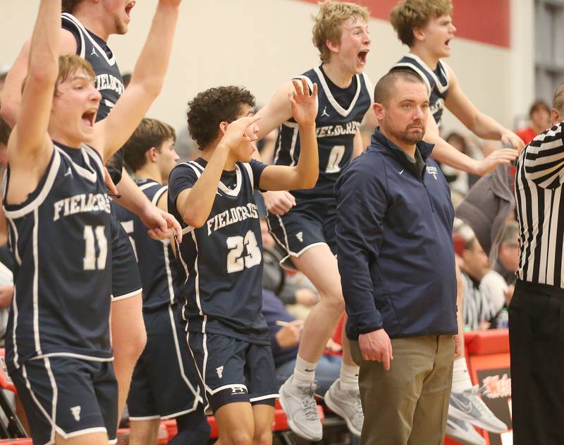 Members of the Fieldcrest boys basketball team (from left) Nathan Cook, Jozia Johnson and Jordan Heider react after defeating L-P during the 49th annual Colmone Classic on Friday, Dec. 8, 2023 at Hall High School.