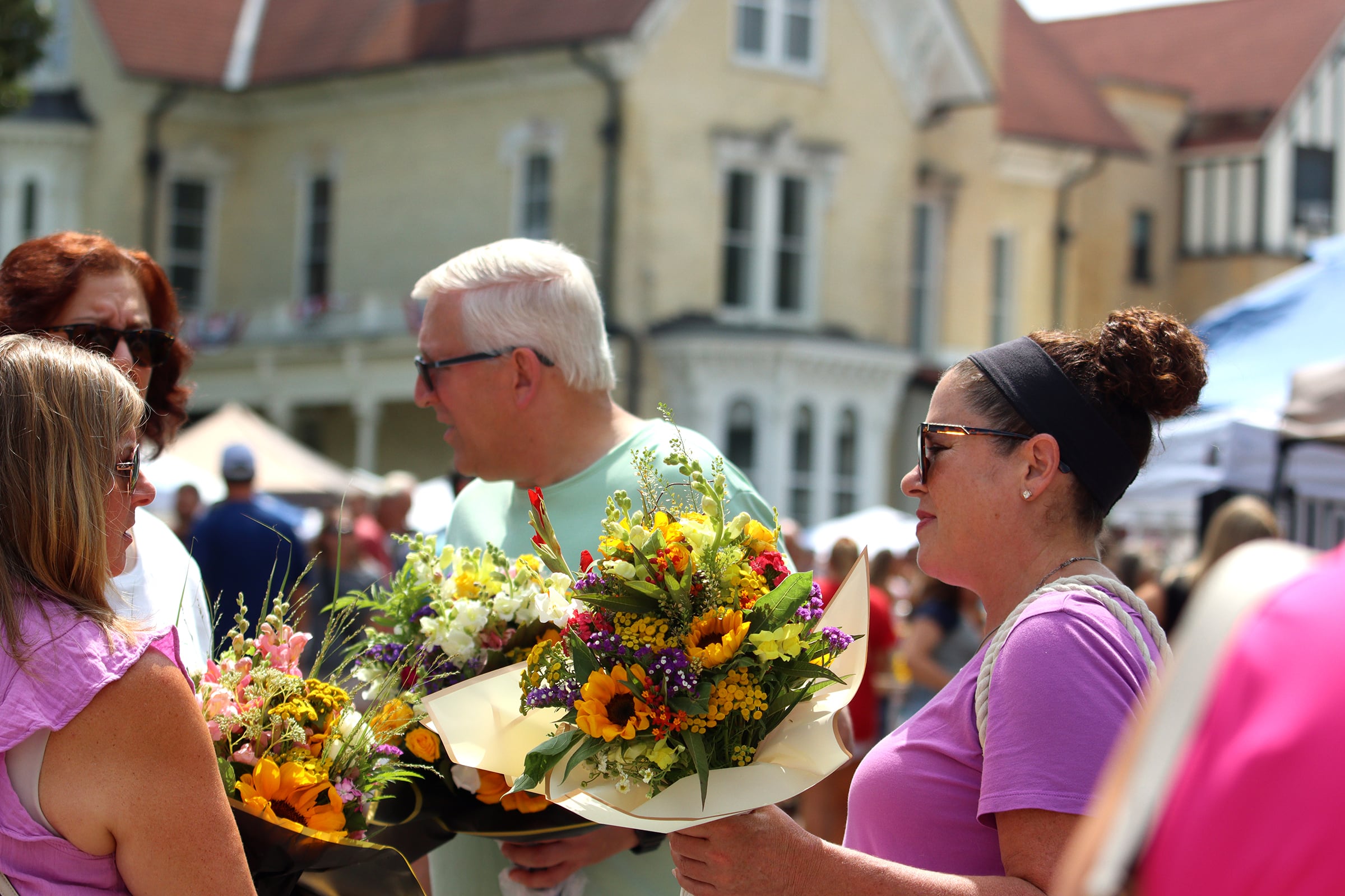 Visitors enjoy The Dole Farmers Market in Crystal Lake Sunday.