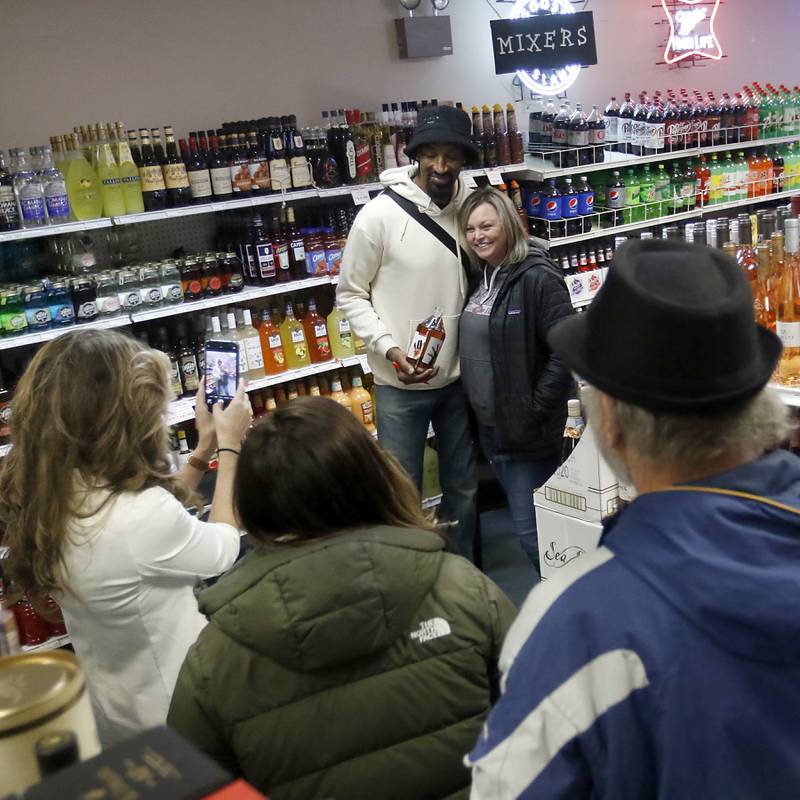 Retired Chicago Bulls star Scottie Pippen poses for a photo after signing a bottle of his Digits bourbon Thursday, Feb. 9, 2023, at The International House of Wine and Cheese, at 11302 Route 12, in Richmond.