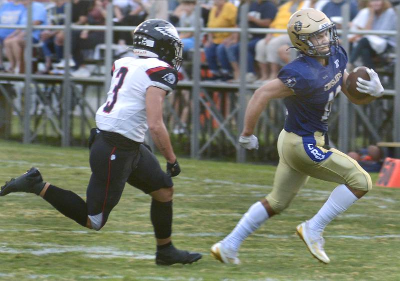 Marquette’s Payton Gutierrez runs to get by Aurora Christian’s Chris Fielding on a run in the 1st quarter Friday at Marquette.