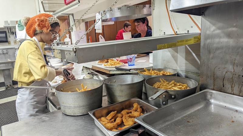 Ashley Botello gets fish dinners ready for customers on Friday, Feb. 17, 2023, at the Knights of Columbus Holy Trinity Council #4400 in Joliet. The Knights of Columbus Holy Trinity Council #4400 hosts a fish fry on Fridays and Saturdays all through the year.