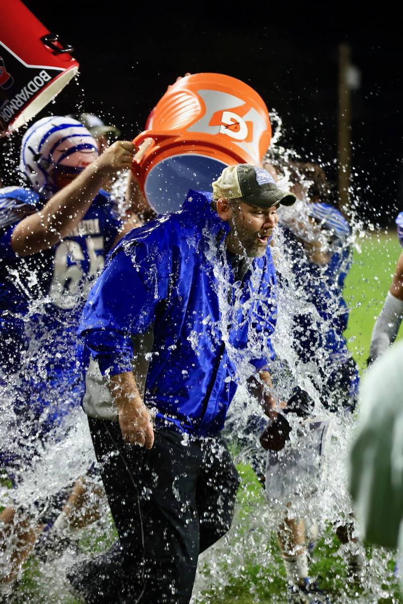 Princeton players douse coach Ryan Pearson after he recorded his 100th career win with Friday's 57-20 win over Mercer County at Bryant Field.