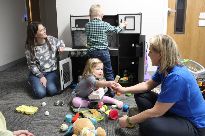 Michelle Nowinski plays with her children, Isabelle, 2, and Teddy, 4, with Options and Advocacy for McHenry County employee Lauren Perkins on Nov. 8, 2023.