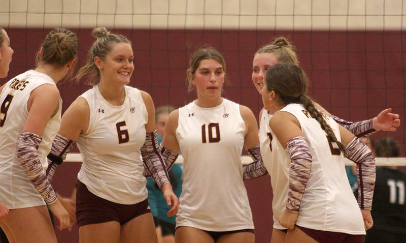 Richmond-Burton’s Elissa Furlan, center left, and Daniella Mazzola, center right, huddle with the Rockets against Woodstock North in varsity volleyball on Monday, Sept. 16, 2024, at Richmond-Burton High School in Richmond.