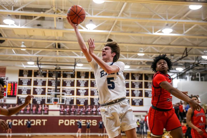 Oswego East's Mason Blanco (5) drives in for a basket during Class 4A Lockport Regional final game between West Aurora at Oswego East.  Feb 24, 2023.