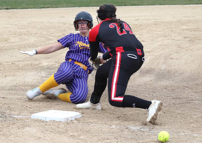 Mendota's Peri Manning slides in safely at third as the ball gets by Indian Creek’s Emily Frazier during their game Thursday, March 14, 2024, at Indian Creek High School in Shabbona.