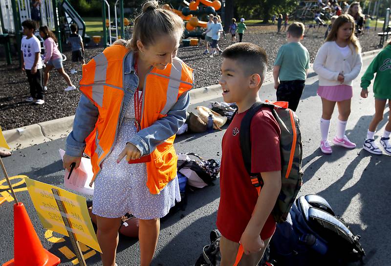 Math instructor Lindsey Copley helps fourth-grader David Lopez find his classes line on the first day of school on Wednesday, Aug. 21, 2024, at Coventry Elementary School in Crystal Lake.