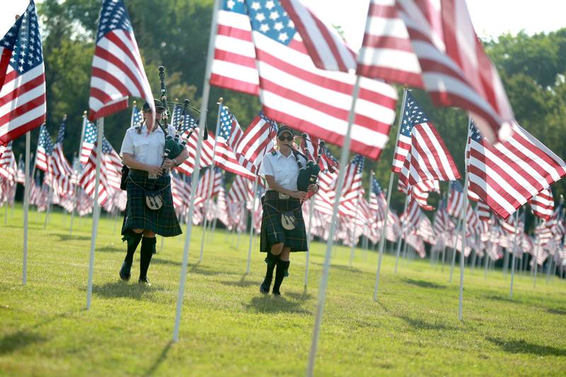 Tunes of Glory bagpipers perform during the opening night of the Field of Honor at Seven Gables Park in Wheaton on Saturday, June 29, 2024.