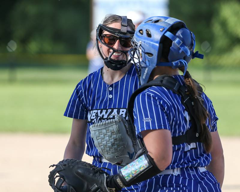 Newark's Kodi Rizzo (20) celebrates a strikeout with Danica Peshia during the Class 1A Newark Regional final game against St. Edwards on Friday, May 17, 2024.
