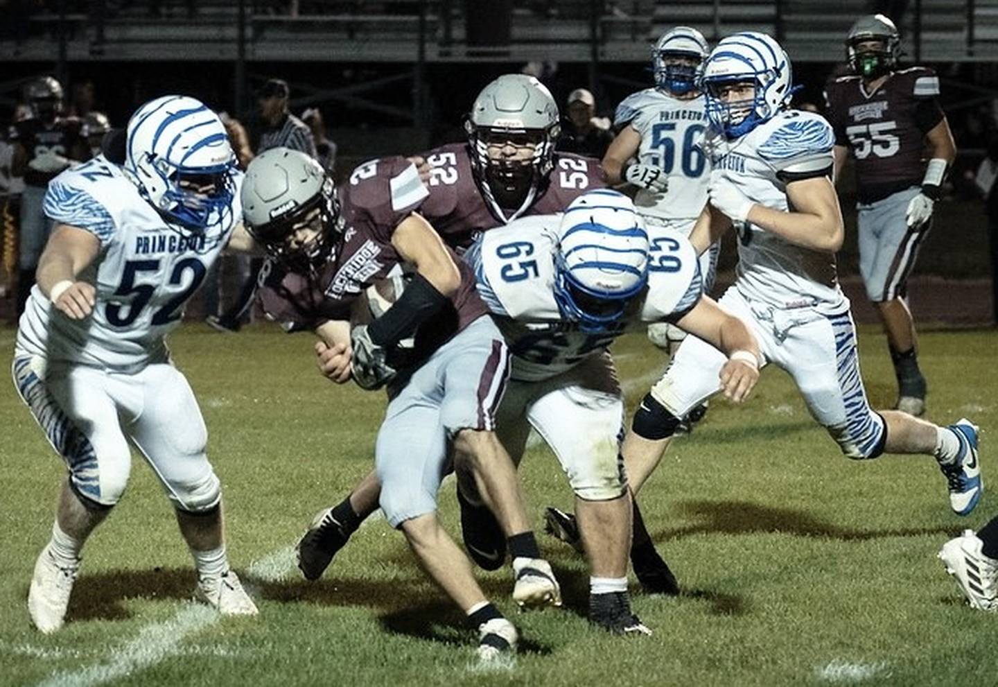 Princeton's Ian Morris (52) and Cade Odell (65) make the stop on Rockridge's Jacob. Freyermuth Friday night. The Tigers won 27-18.