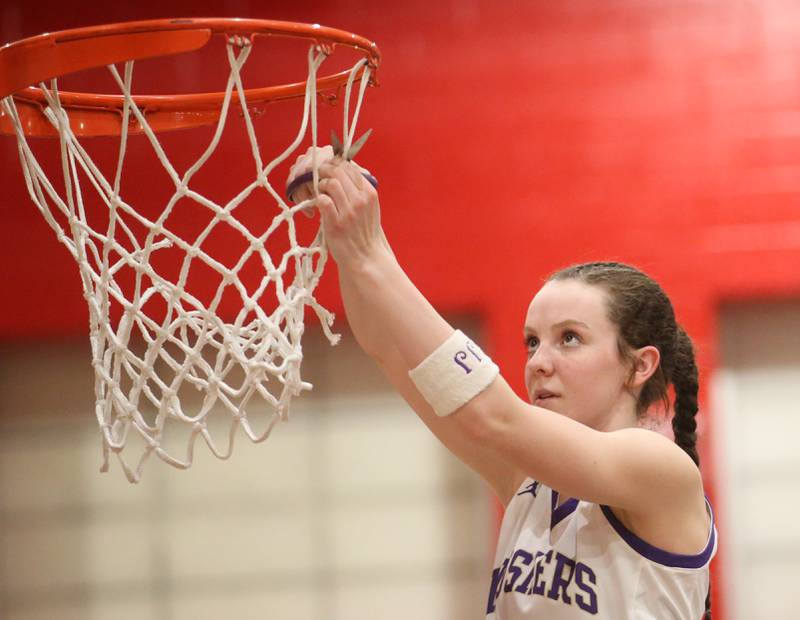 Serena's Gwen O'Connell cuts a piece of the net down after defeating Ashton-Franklin Center in the Class 1A Regional on Thursday, Feb. 15, 2024 at Earlville High School.