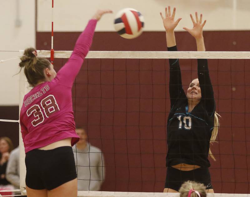 Richmond-Burton's Elissa Furlan tries to spike the ball over the block of Woodstock North’s Danielle Hansen during a Kishwaukee River Conference volleyball match Wednesday, Oct.11, 2023, at Richmond-Burton Community High School.