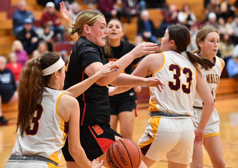 Batavia's Sarah Hecht (middle) loses the ball as she is fouled by Loyola's Aubrey Galvan during a Coach Kipp Hoopsfest game on Jan. 13, 2024 at Montini Catholic High School in Lombard.