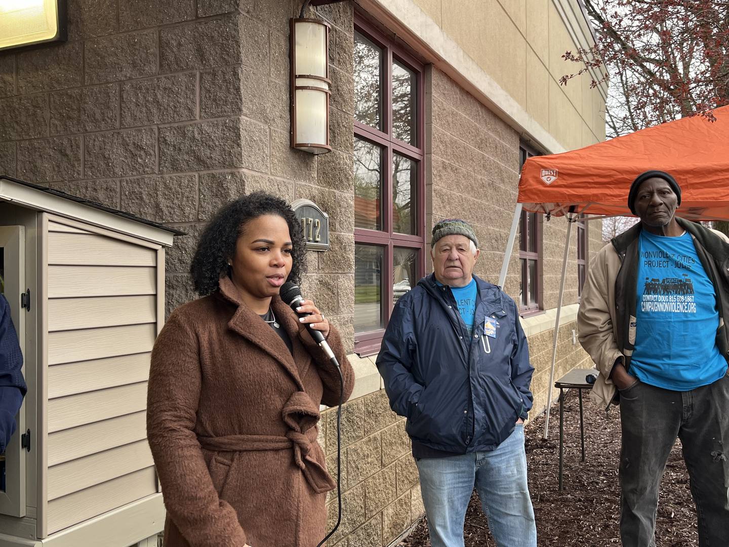 Keshia Ellis, the new director of Peace Over Violence (left), speaks on Thursday, April 4, outside the Ozzie and Peggy Mitchell Center in Joliet.