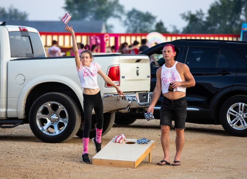 David Froelich, right, and Anne Donohue, 11, play bags during the 'Barbie' movie premiere at the McHenry Outdoor Theater on Friday,  July 21, 2023.