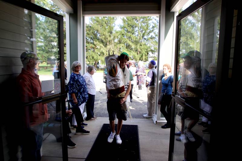 Congregation members march into their new location as the McHenry County Jewish Congregation moved items from their Ridgefield Road location to the Tree of Life Unitarian Church in McHenry on Sunday, August 18.