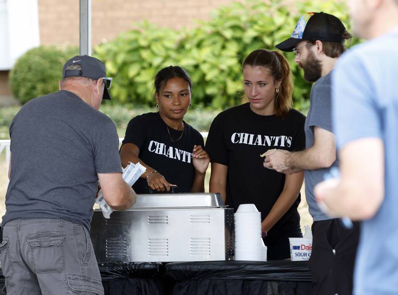 Mercedez Tucker, left, and Mackenzie Krouse of Chianti’s help customers  on the first day of the Festival of the Vine Friday, Sept. 6, 2024 in Geneva.