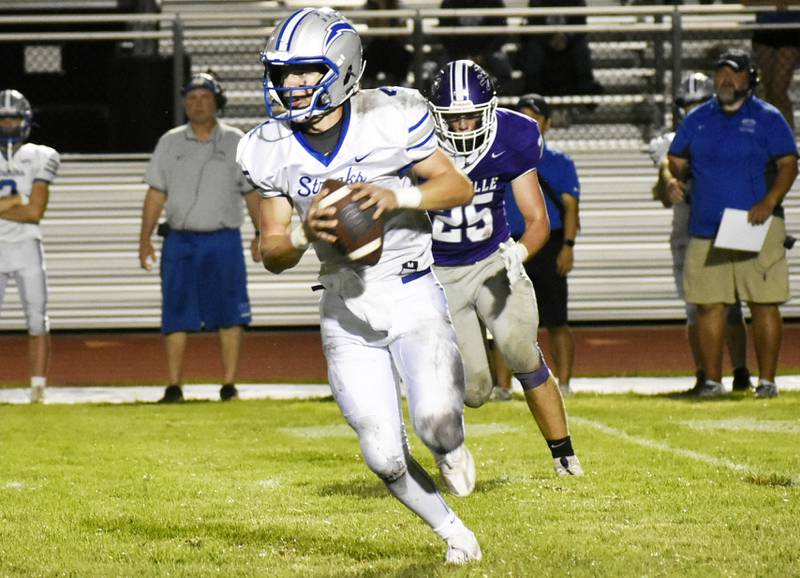 Woodstock’s Caden Thompson evades pressure from Rochelle’s Brode Metzger during Friday’s evening nonconference matchup at Rochelle Township High School.