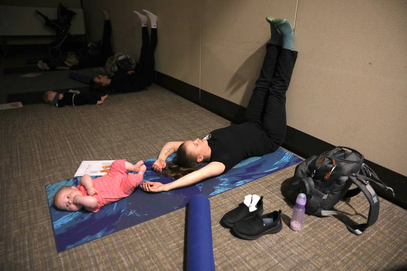 Megan Drennan of St. Charles and her daughter, Enid, 3 months, participate in a baby yoga class at Northwestern Medicine Delnor Hospital in Geneva.