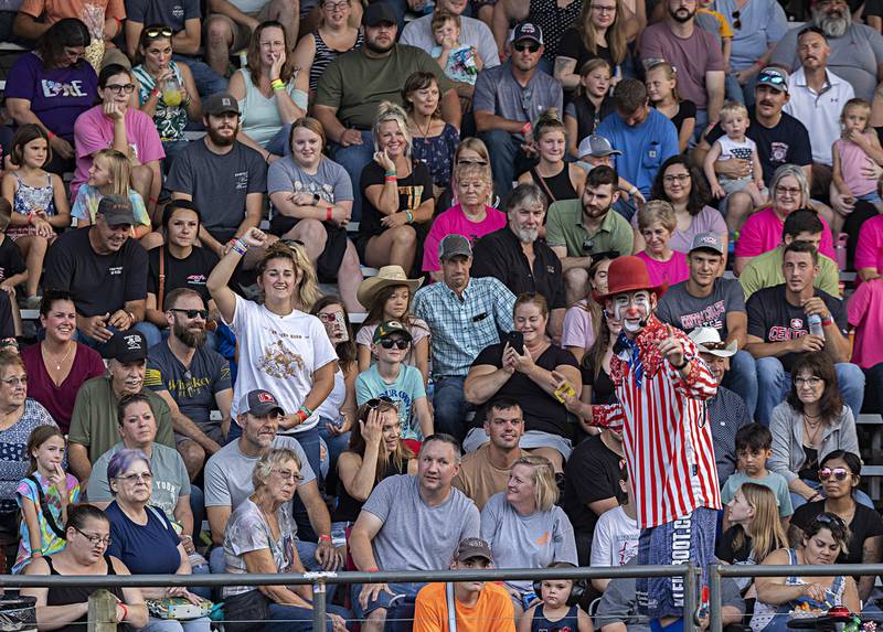 Ava Parkinson (left with arm raised) of Shannon does her best bull riding impression at the Rice Bull Riding and Barrel Racing event Thursday, August 11, 2023 at the Carroll County fair. With her outstanding impression, Parkinson was awarded a gift card for Wrangler jeans.