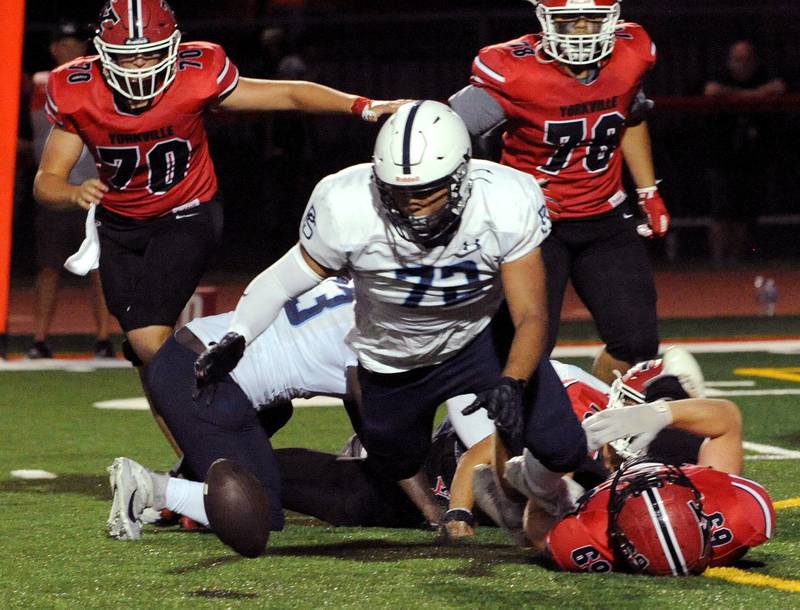 Plainfield South's Jacob Aguilar (72) recovers a Yorkville fumble on Friday, Sep. 30, 2024, at Yorkville High School.