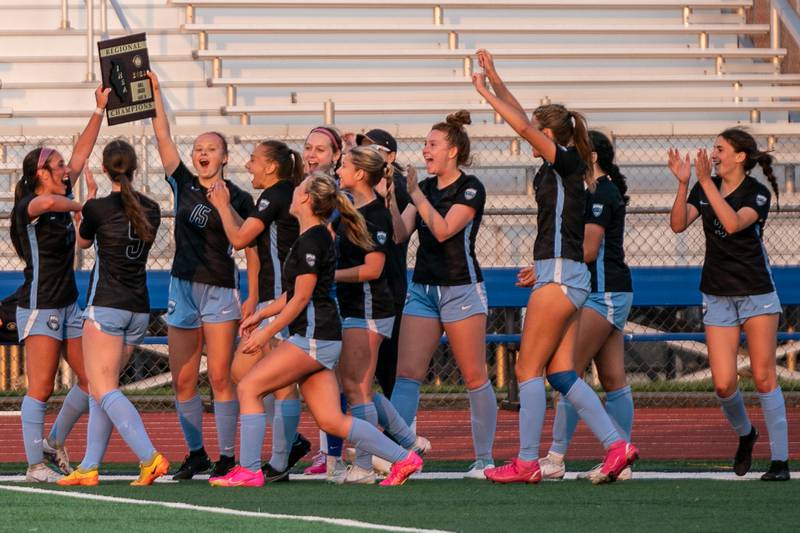 St. Charles North players celebrate their victory over Wheaton Warrenville South to win the Class 3A girls soccer regional final at St. Charles North High School on Friday, May 19, 2023.