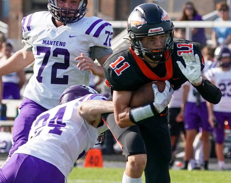 Sandwich Nick Michalek (11) carries the ball against Manteno during a football game at Sandwich High School on Saturday, Aug 26, 2023.