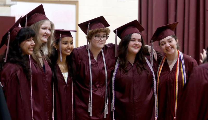 Members of the Prairie Ridge High School Class of 2024 pose for pictures before commencement at the school in Crystal Lake on Saturday.