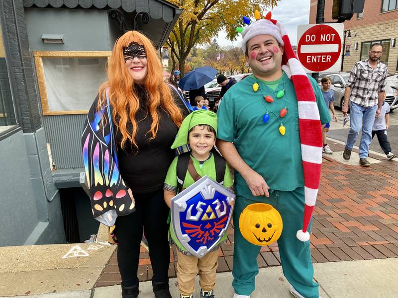 (From left) Mom Daiynaa Alvarez, son Liam Alvarez, 7, dressed as the hero Link from "The Legend of Zelda" video game series, and Dad Ronny Alvarez pose while trick-or-treating during the 26th annual Spooktacular event in downtown DeKalb Thursday, Oct. 26, 2023 hosted by the DeKalb Chamber of Commerce.