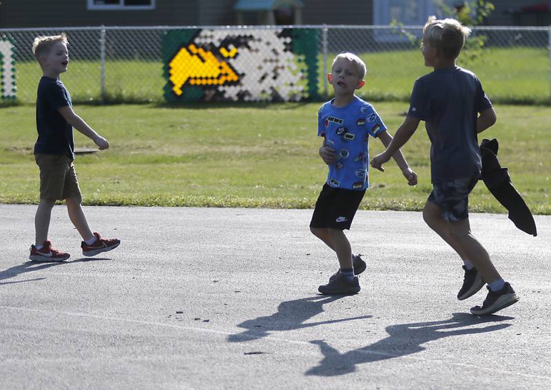 Children play in front of the school’s mascot before the first day of school on Wednesday, Aug. 21, 2024, at Coventry Elementary School in Crystal Lake.