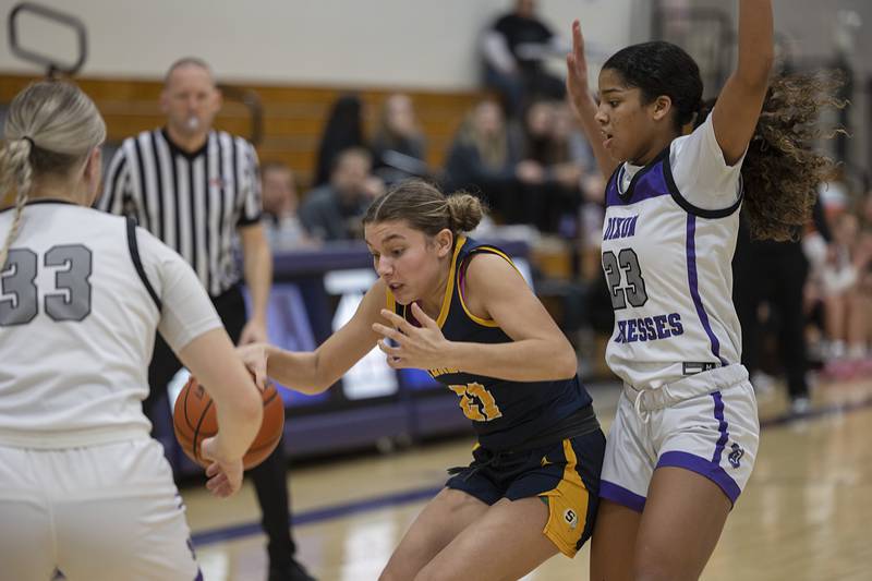 Sterling’s Jae James handles the ball against Dixon’s Ahmyrie McGowan Tuesday, Feb. 13, 2024 during a regional semifinal at Rochelle.