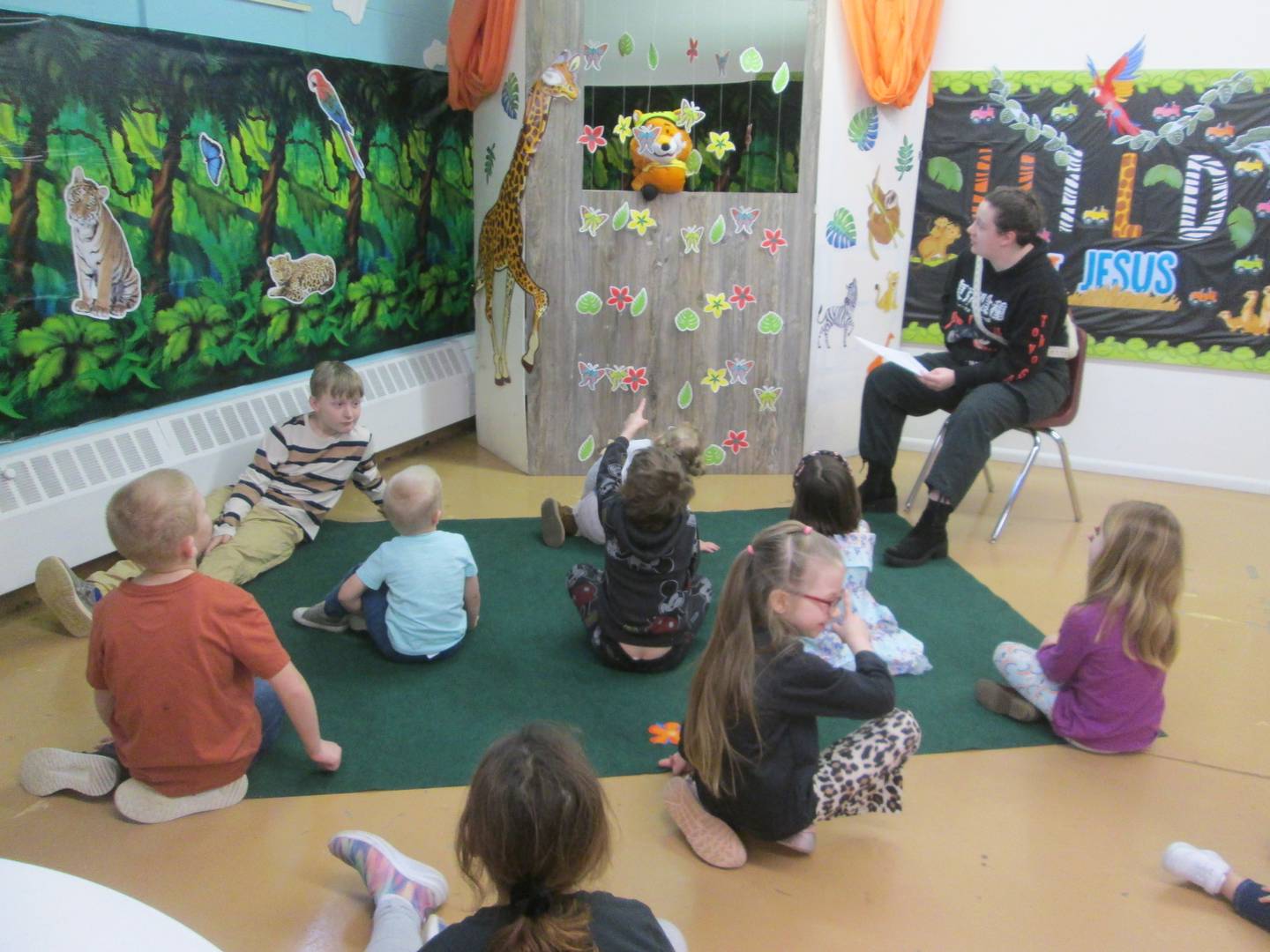 Plano Methodist Church Sunday School children listen to Angeleah Wyncoop and “Archie” the puppet as they talk about their next adventure. The church taught lessons from the New Testament in May.