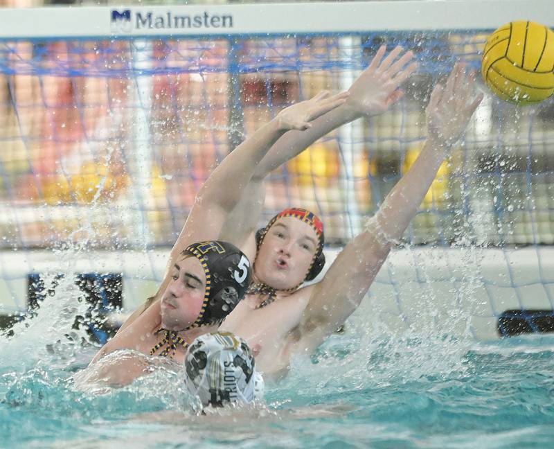 Lyons goalkeeper Charlie Vlk and teammate Ben Kozak defend against a Stevenson shot in the IHSA boys water polo championship in Lincolnshire on Saturday, May 18, 2024.