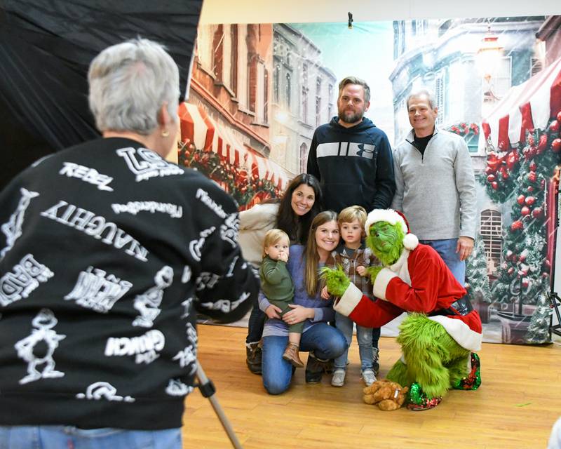 The Moore Family from DeKalb and Sycamore pose with the Grinch during the Sycamore Chamber of Commerce's annual Moonlight Magic event held in downtown Sycamore on Friday, Nov. 17, 2023.