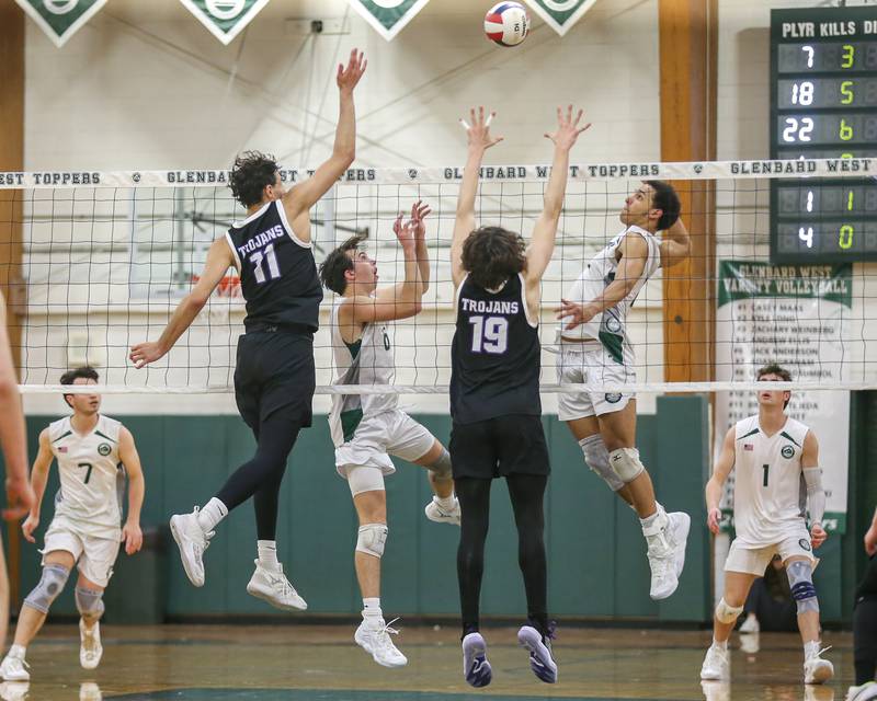 Glenbard West's Jack Anderson (6) sets a shot for Xzavion Willett during volleyball match between Downers Grove North at Glenbard West.  April 2, 2024.