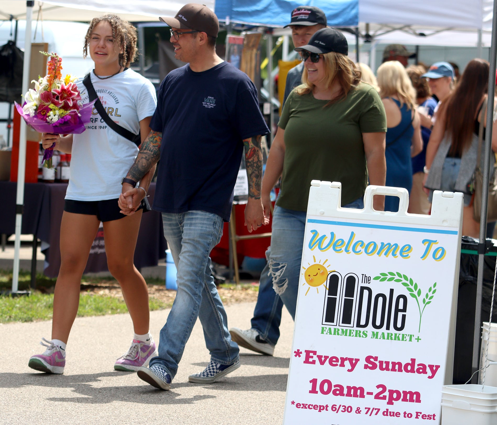 Visitors enjoy The Dole Farmers Market in Crystal Lake Sunday.