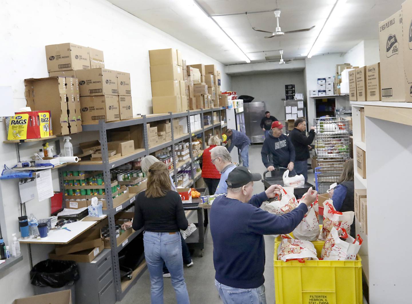 Volunteers sort, restock and pick food on Tuesday, Jan. 10, 2023, as they work inside the FISH of McHenry Food Pantry, 3515 N. Richmond Road in Johnsburg. The pantry, which has changed how it distributes food since the COVID-19 pandemic, is now raising $150,000 to add more storage and a heated garage onto the building.