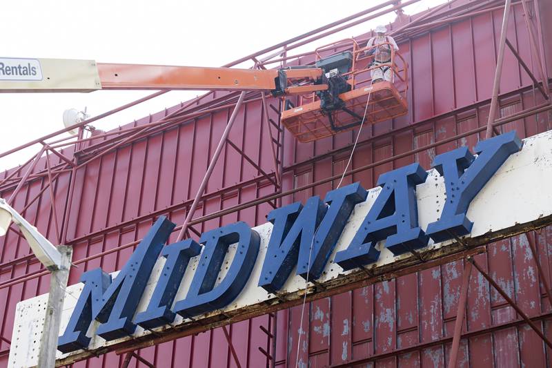 Kevin Street works high atop a lift Tuesday, August 22, 2023 while working to renovate the Midway Drive-In movie screen outside of Sterling. Tucker Painting of Dixon has been tasked to spruce up the screen.