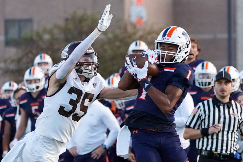 Oswego’s Jeremiah Cain (1) catches a pass against Joliet Catholic's Michael Jaworski (35) during a football game at Oswego High School on Friday, Sep 6, 2024.